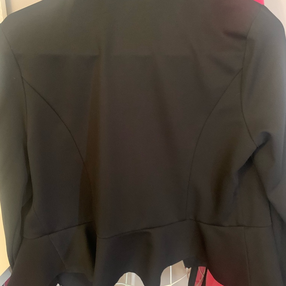 Black jacket with ruffle bottom